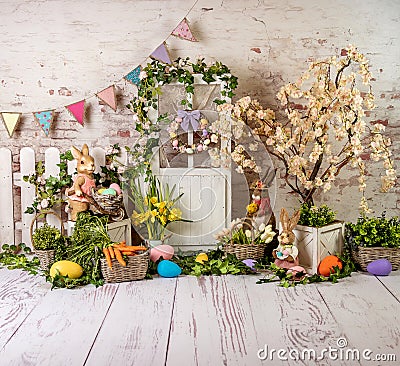 Easter spring sett up with colourful flowers pink and yellow flowers,bunny and easter eggs and vintage wood parquet Stock Photo