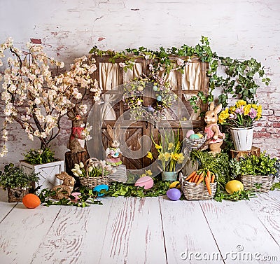 Easter spring sett up with colourful flowers pink and yellow flowers,bunny and easter eggs and vintage wood parquet Stock Photo