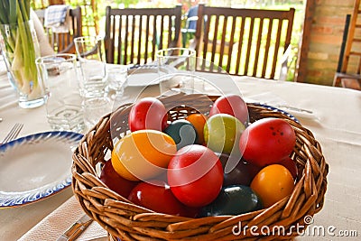 Easter tablewear outdoor under the pergola with colorful eggs in a sunny day Stock Photo