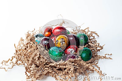 Easter traditions. colorful quail eggs in the nest Stock Photo