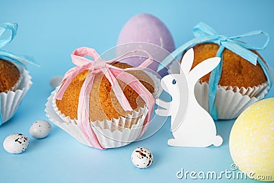 Easter treats, colorful cupcakes on a blue background, close-up Stock Photo
