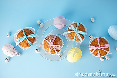 Easter treats, colorful cupcakes on a blue background. Flat lay Stock Photo