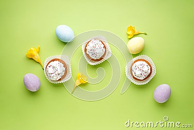 Easter treats, colorful cupcakes on a light green background. Flat lay Stock Photo