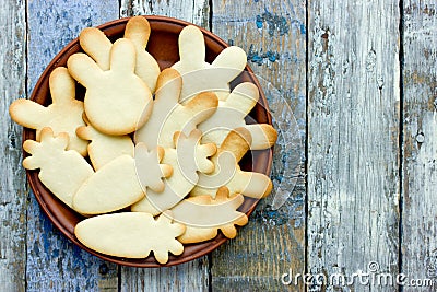 Easter treats for kids - shortbread bunnies and carrots on wooden background Stock Photo