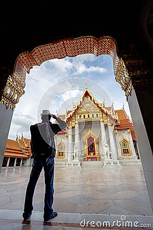 Eastern Asia summer holidays. Asian man tourist looking at Wat Benchamabopitr Dusitvanaram Bangkok Thailand. Asia tourist, Editorial Stock Photo