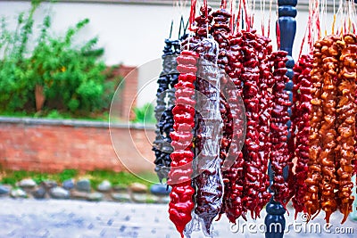 Eastern sweets. Multi-colored churchkhela hanging in the market Stock Photo