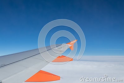 Easy-jet airplane wing view on air blue sky clouds Editorial Stock Photo