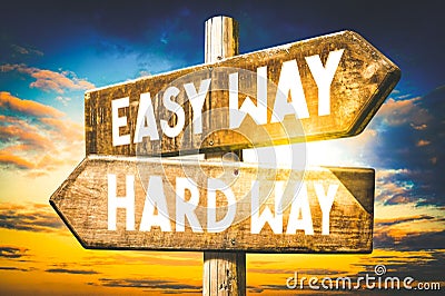 Easy way, hard way - wooden signpost, roadsign with two arrows Stock Photo