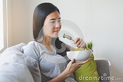Eat healthy food on wellness lifestyle. Beauty young woman eating salad as a breakfast Stock Photo
