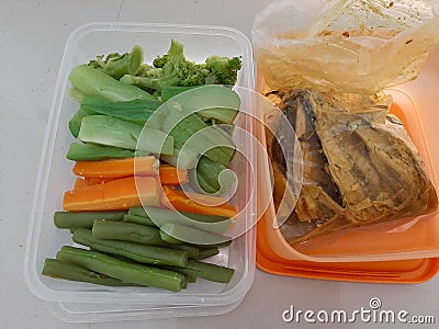 Eat healthy foods of boiled vegetables and fish that are healthy for the body. Stock Photo