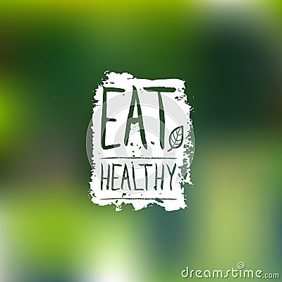 Eat healthy vector logo with hand lettering. Organic food label on blur background for vegan cafe, product packaging. Vector Illustration