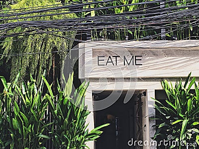 EAT ME sign Front gate of garden style cafe and restaurant Stock Photo