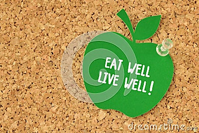 Eat well, Live well! written on apple shaped paper note on pinboard Stock Photo