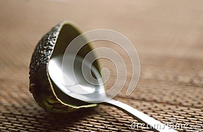 Eaten avocado peel with a spoon on the table Stock Photo