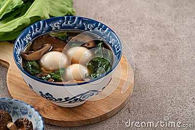 Eating big tangyuan yuanxiao with savory soup in Taiwan Stock Photo