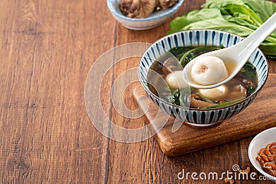 Eating big tangyuan yuanxiao with savory soup in Taiwan Stock Photo