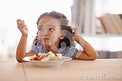 Eating child, breakfast and fruit salad at home with happiness and wellness meal with a smile. House, nutrition and Stock Photo
