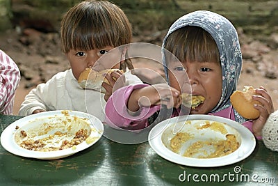 Eating children during food distribution Editorial Stock Photo