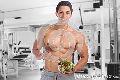 Eating food salad bodybuilding bodybuilder gym body builder building muscles muscular young man Stock Photo