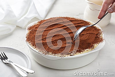 Eating homemade tiramisu, Italian dessert with ladyfinger biscuits, coffee Stock Photo