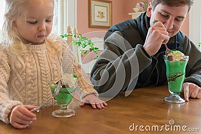 Eating ice cream sundaes decorated for St. Patrick`s Day Stock Photo