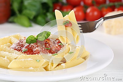 Eating Penne Rigate Napoli with tomato sauce noodles pasta meal Stock Photo