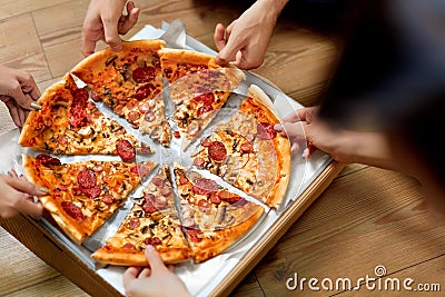 Eating Pizza. Group Of Friends Sharing Pizza. Fast Food, Leisure Stock Photo