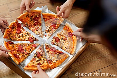 Eating Pizza. Group Of Friends Sharing Pizza. Fast Food, Leisure Stock Photo
