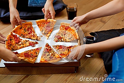 Eating Pizza. Group Of Friends Sharing Pizza. Fast Food, Leisure Stock Photo