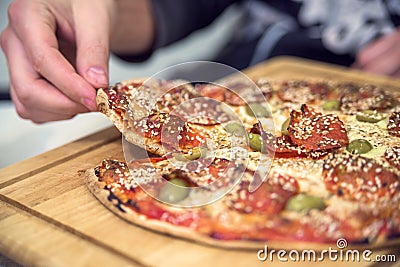 Eating Pizza. Group Of Friends Sharing Pizza Together. Stock Photo