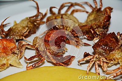Eating shell crabs and cornmeal mush, background Stock Photo