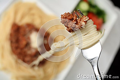 Eating spaghetti bolognaise Stock Photo