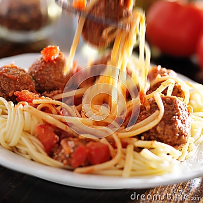 Eating spaghetti and meatballs with visible motion blur Stock Photo