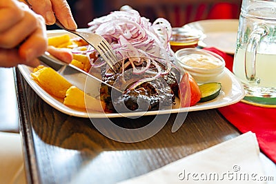 Eating spare ribs in a german or austrian restaurant Stock Photo