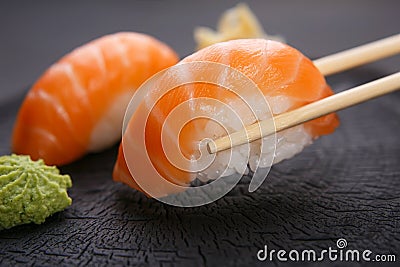Eating sushi. Delicious Japanese cuisine, nigiri sushi with salm Stock Photo