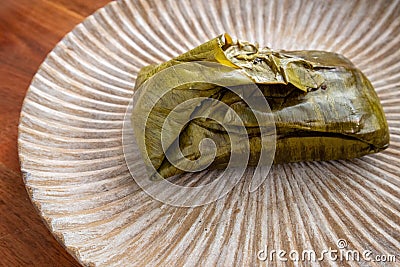 Eating Tamales in Oaxaca, Mexico. The tamale is masa filled with mole negro.. Stock Photo