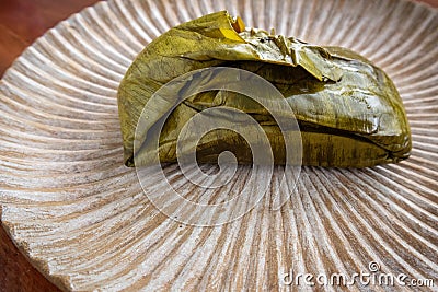 Eating Tamales in Oaxaca, Mexico. The tamale is masa filled with mole negro.. Stock Photo