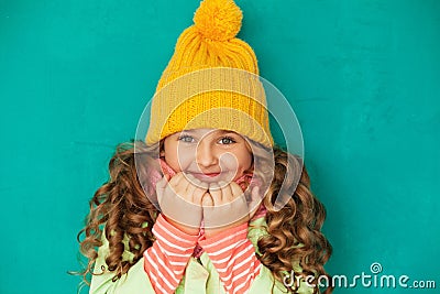 Eautiful little lady wearing yellow woolen cap and scarf Stock Photo