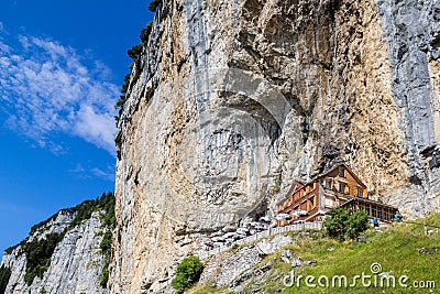 The guest house Aescher - Wildkirchli against the Aescher cliff Editorial Stock Photo