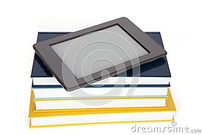 Ebook reader with empty screen on top of pile of paper books. Stock Photo