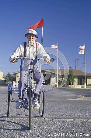 An eccentric senior citizen riding a tricycle Editorial Stock Photo