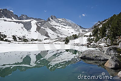 Echo Peak Reflected In A Partially Frozen Moonlight Lake Stock Photo