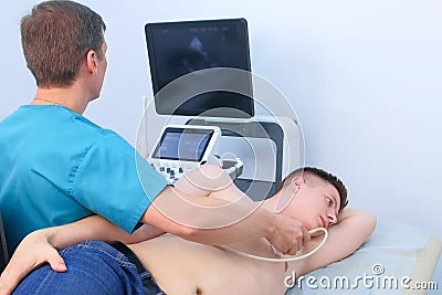 Echocardiography. Doctor examining patient heart by using ultrasound equipment. Stock Photo