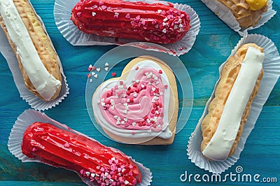 Eclairs with valentines day decor and heart shaped cookie Stock Photo