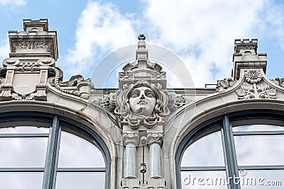 Eclecticism in architecture, head sculpture classic antique building exterior detail up close, old tenement house front view Stock Photo