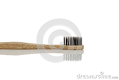 Eco charcoal toothbrush with wooden handle. Caring for nature. Isolated on white background. Space for text Stock Photo