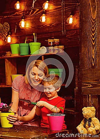 Eco concept. Eco and ecology. Be eco friendly and go green. Little child help mother planting flower to new pot, eco Stock Photo