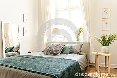 Eco cotton linen and blanket on a bed in nature loving family guesthouse for spring and summer vacation. Real photo. Stock Photo