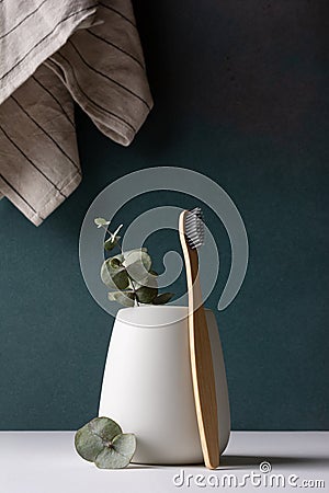 Eco-friendly bamboo toothbrushes in a white holder Stock Photo