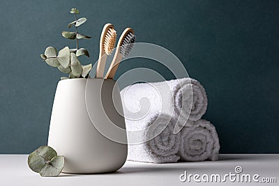 Eco-friendly bamboo toothbrushes in a white holder Stock Photo